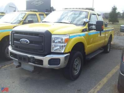 Ford F-250 Super Duty pickup truck with plow, yellow with blue stripe, front grille view