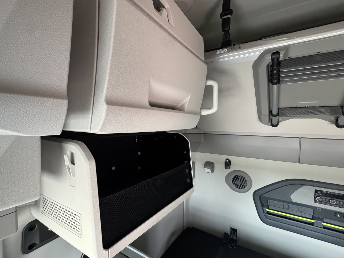 Volvo VNL64T860 truck interior cab area with storage compartments and control panel visible.