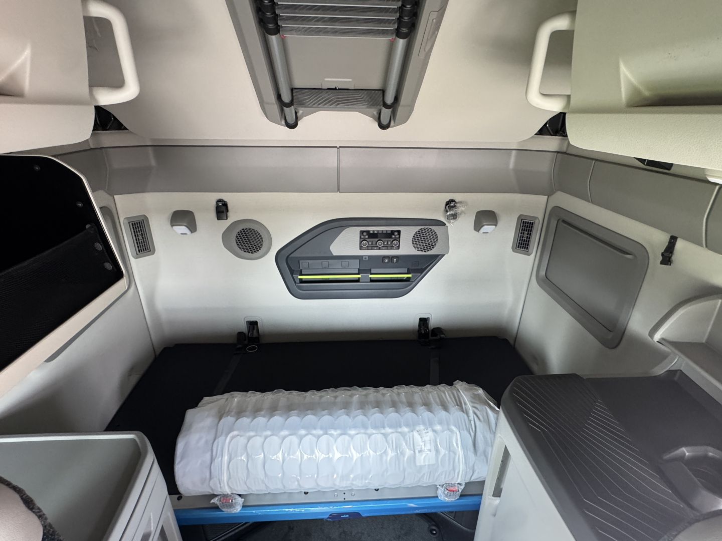 Volvo VNL64T860 sleeper cab interior showing control panel, storage compartments, and roof vents.
