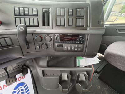 Volvo truck dashboard and center console showing gear shifter and control switches.