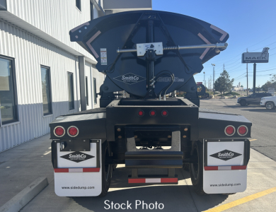Rear view of a SmithCo SX2-4034 dump trailer showing taillights, mud flaps with SmithCo logos, and a raised spreader/auger mechanism.