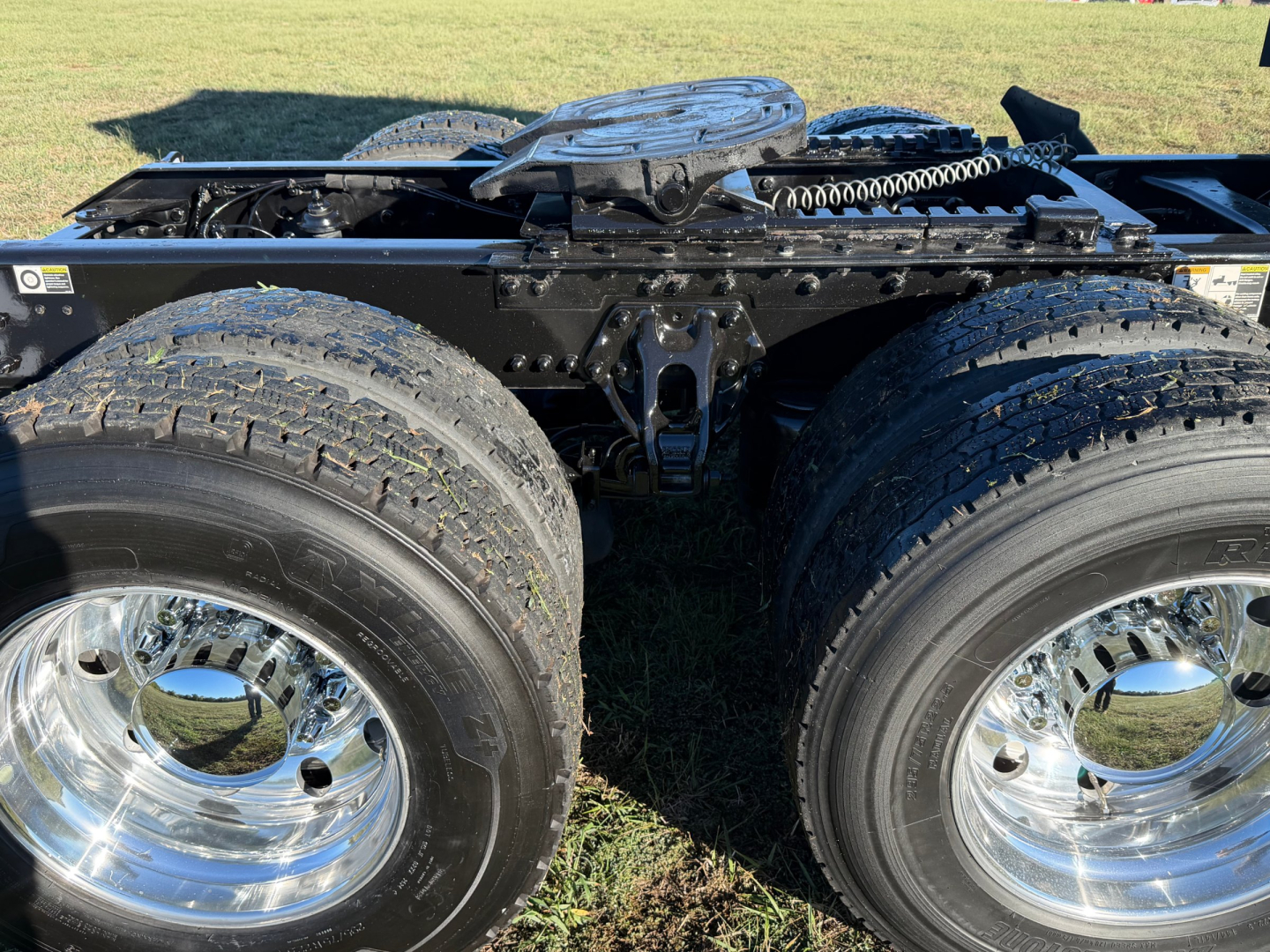 Kenworth T680 chassis with dual rear axles and chrome wheels, view of the frame and fifth wheel area.
