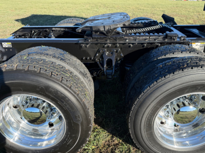 Kenworth T680 chassis with dual rear axles and chrome wheels, view of the frame and fifth wheel area.