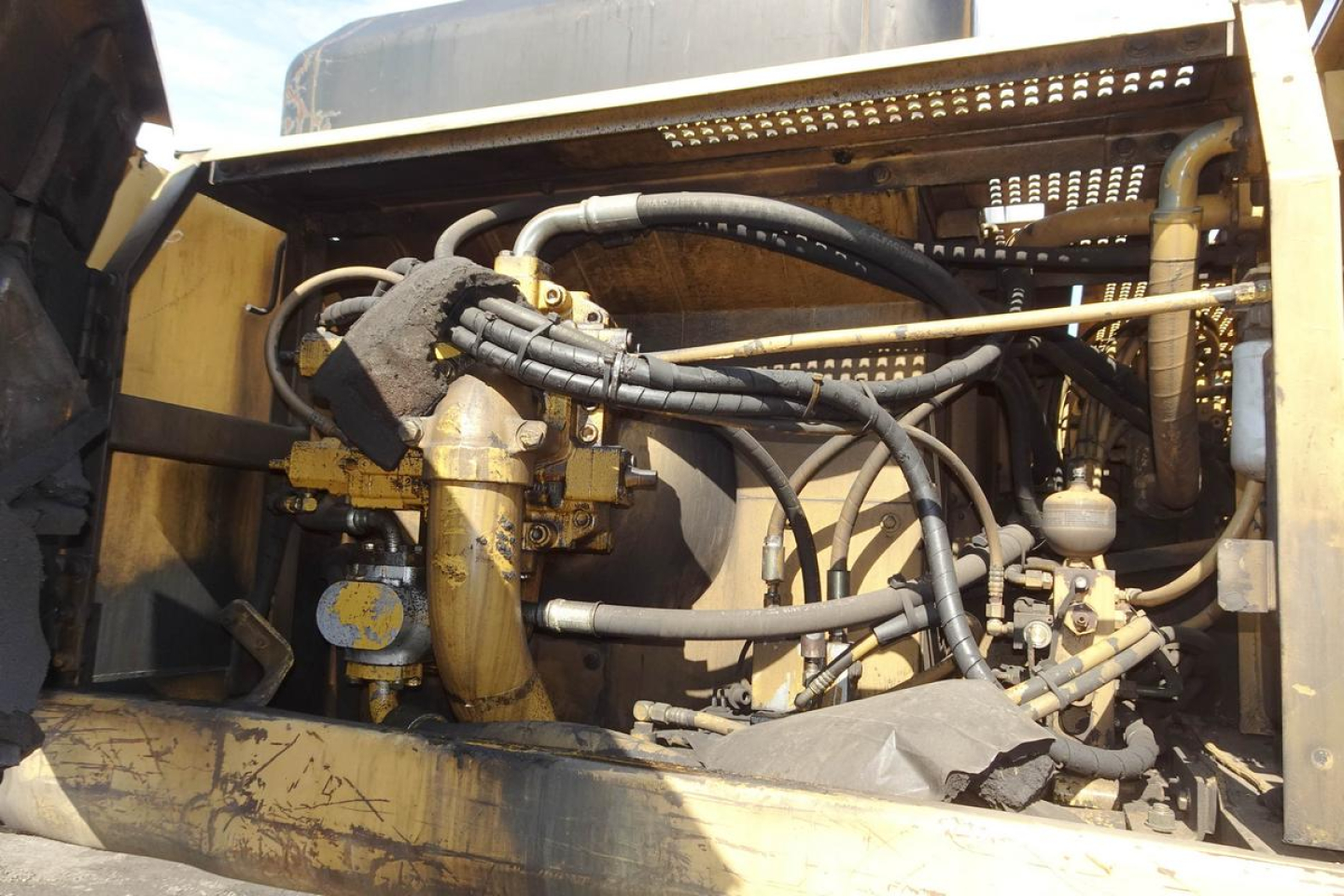 Caterpillar 330L MH engine bay showing hydraulic hoses and components in serviceable condition.