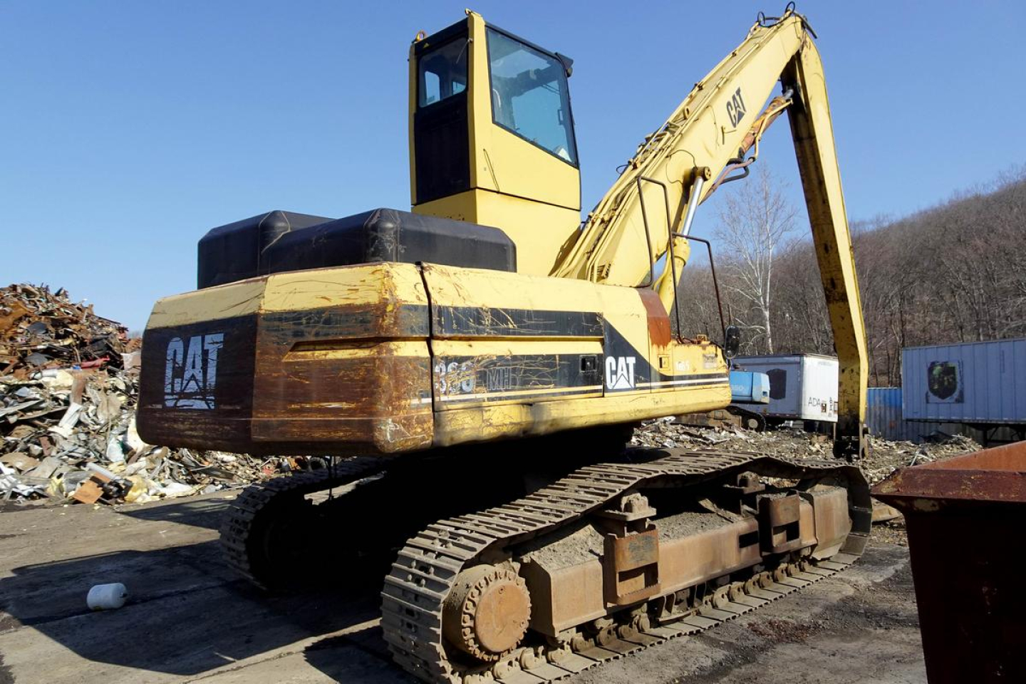 Caterpillar 330L MH excavator in serviceable condition with tracked undercarriage and yellow paint, side view showing CAT branding and WINCH/boom arm.