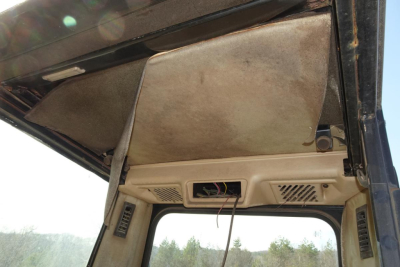 Caterpillar 330L MH cabin interior showing headliner and sun visor area.