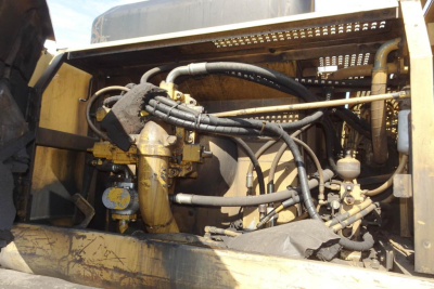 Caterpillar 330L MH engine bay showing hydraulic hoses and components in serviceable condition.