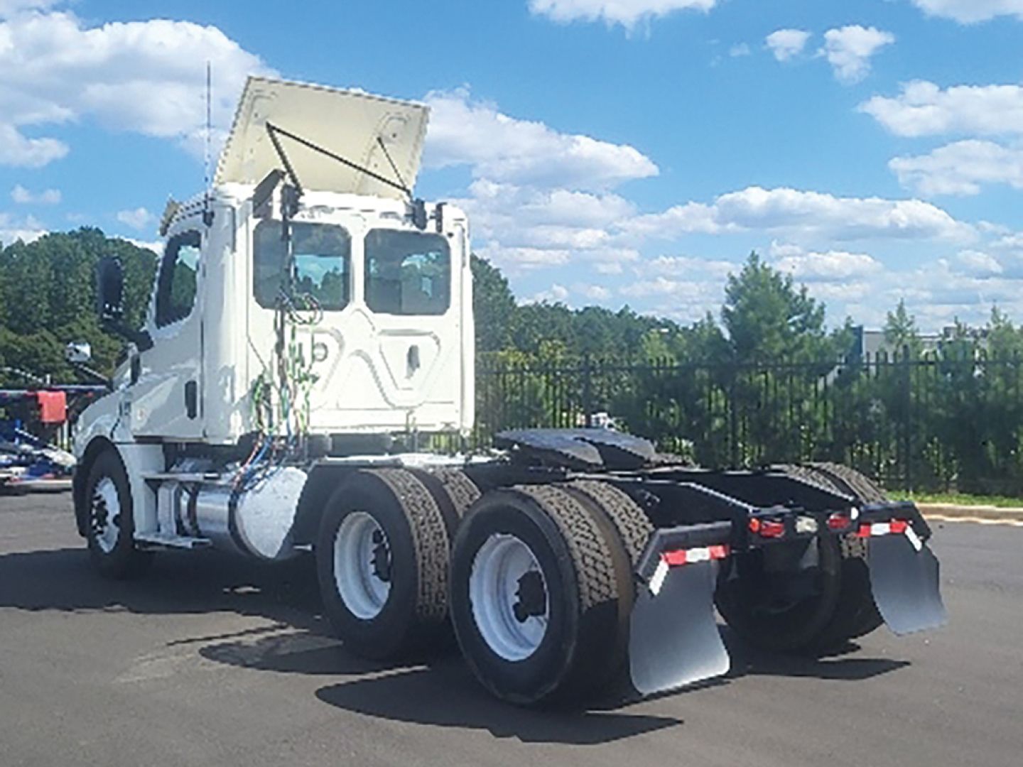 Truck chassis view of a 2019 Freightliner Cascadia 126 daycab. Visible are the rear twin axles, mud flaps, and cab with sleeper area; no legible labels or numbers in view.