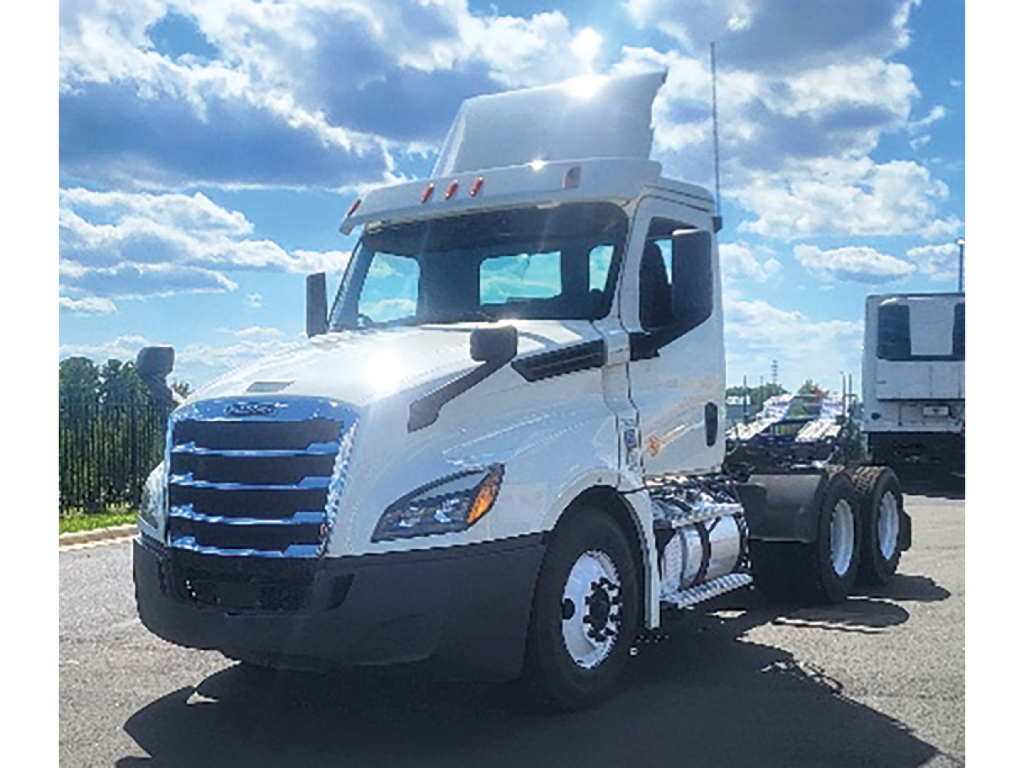 Truck front view of a white 2019 Freightliner Cascadia 126 Daycab tractor with blue grille, large mirrors, and sun visor.
