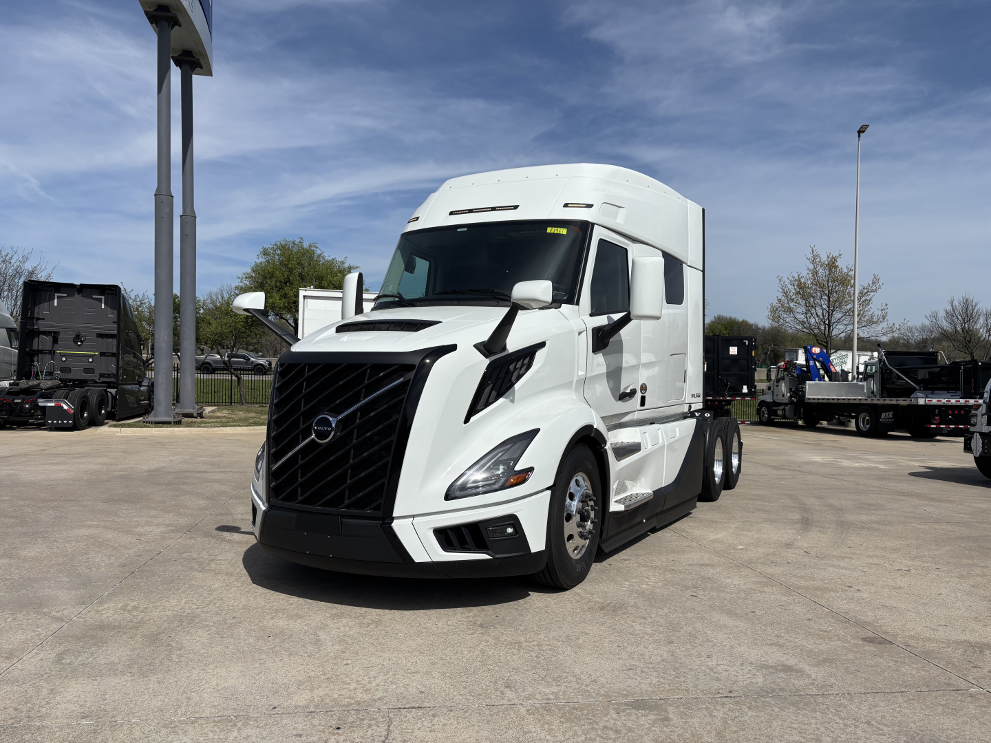 Volvo VNL64T640 tractor-trailer in white, front three-quarter view, showing aerodynamic cab and grille.