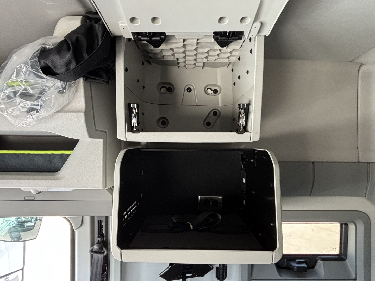 Volvo VNL64T640 truck cockpit area showing storage compartment under dash with open cubby and overhead console
