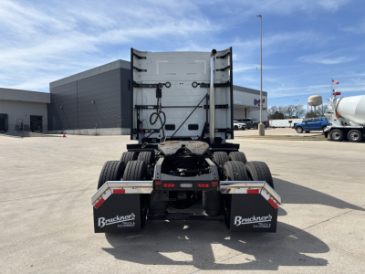 Back view of a new 2027 Volvo VNL64T640 tractor, showing fifth wheel, rear mud flaps with Bruckner's logo, and dual rear tires.
