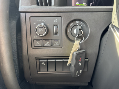 Volvo VNL64T640 dash panel with headlight switch, traction control buttons, and ignition with key fob visible