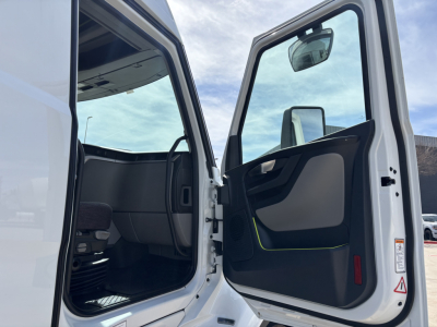 Volvo VNL64T640 sleeper cab interior with open door showing dashboard and entry area.