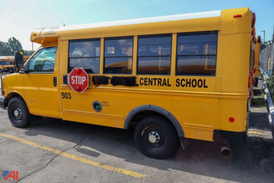 School bus side view with yellow body, Central School lettering, stop sign near front door, 503 fleet number, and black wheel well trim.