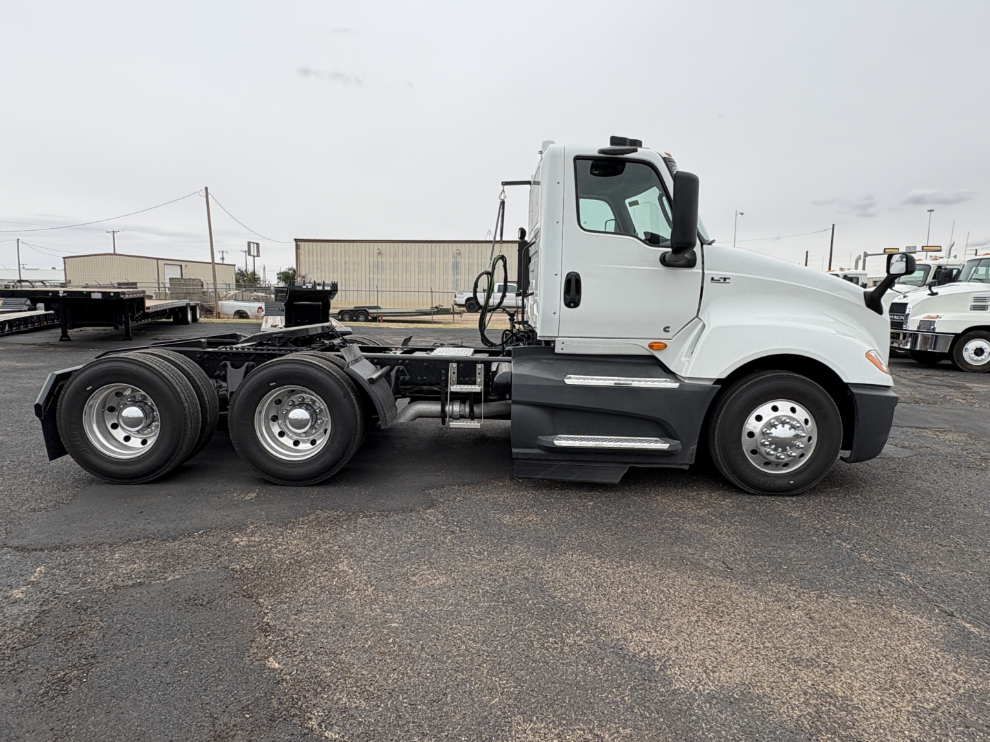 Truck side view showing International LT625 cab and chassis with dual rear axles, no trailer attached.