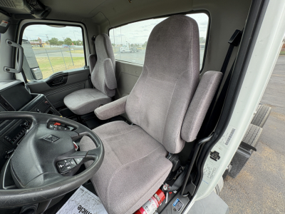 Truck cab interior showing driver and passenger seats with steering wheel and dashboard of a 2021 International LT625 LT cab. Visible text on dashboard and controls but no clear model-specific labels.