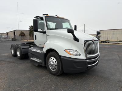 Truck cab with International LT625 branding showing front grille, side mirrors, and 6-wheel configuration; no visible text other than optional model badges.