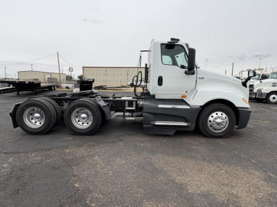Truck side view showing International LT625 cab and chassis with dual rear axles, no trailer attached.