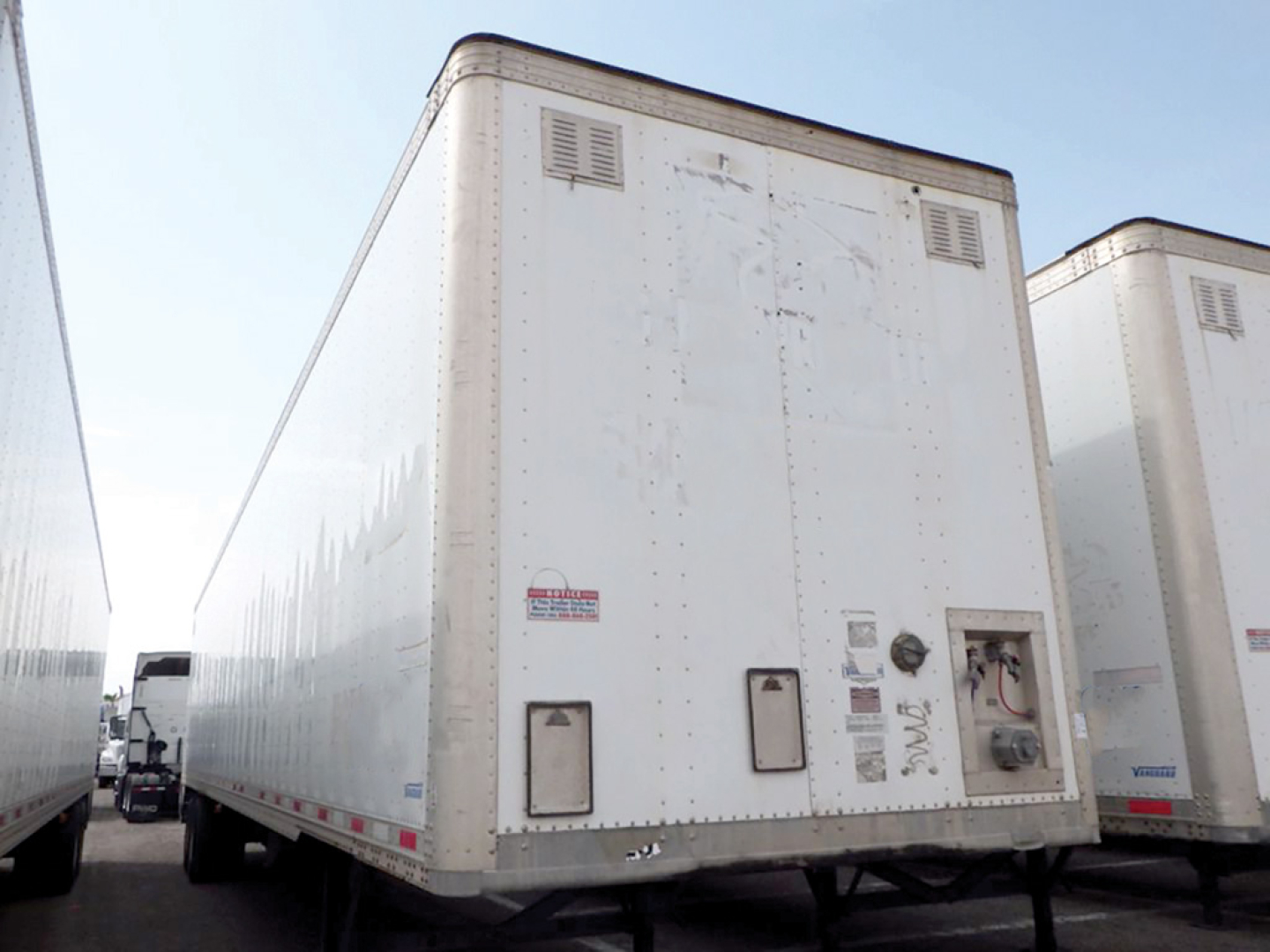 Trailer rear view showing white Hyundai aluminum dry van with vent panels and rear doors, used condition.