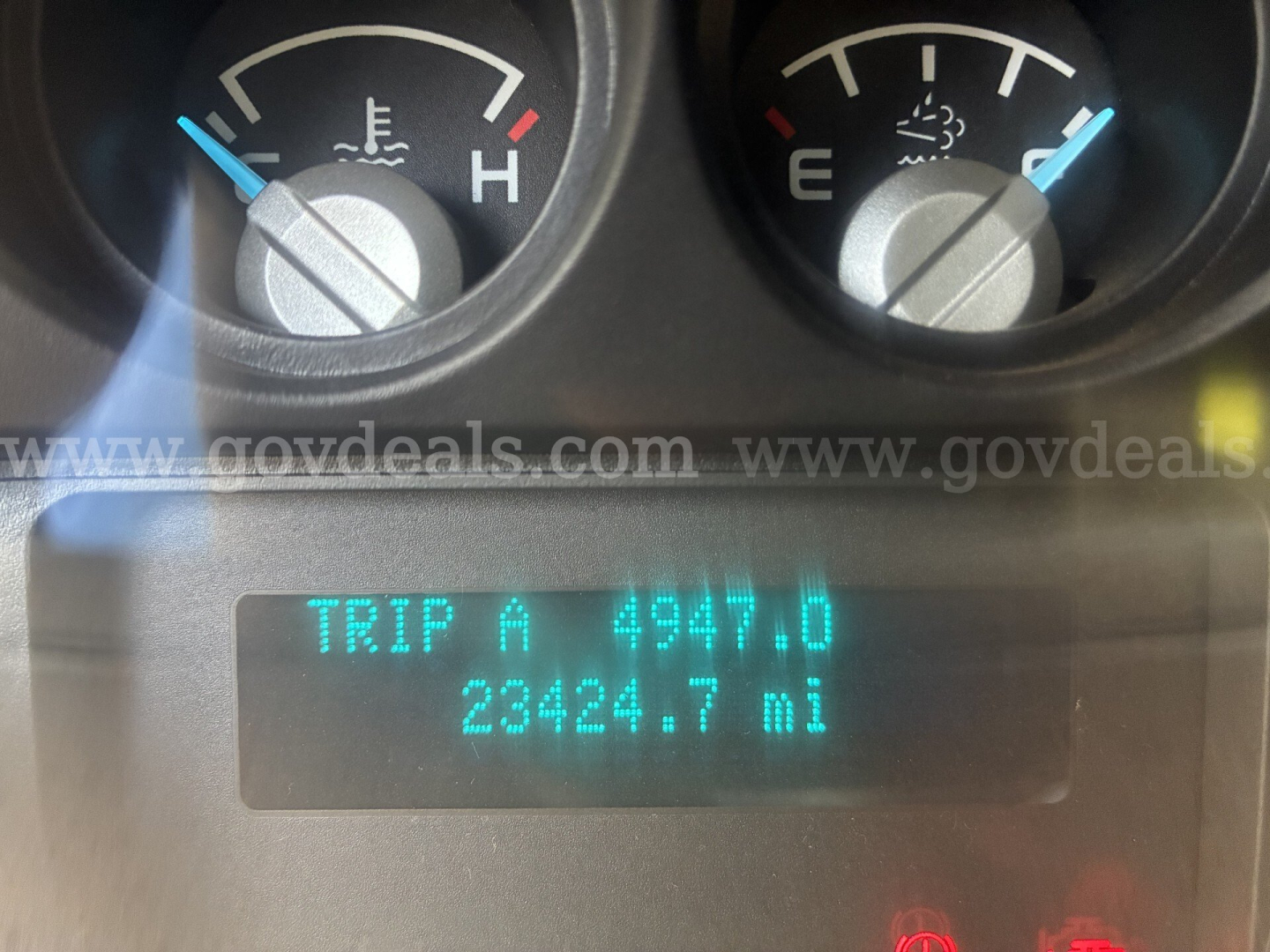 Gauges and digital odometer display showing TRIP A 4947.0 and 23424.7 mi on a Ford F-750 instrument cluster.