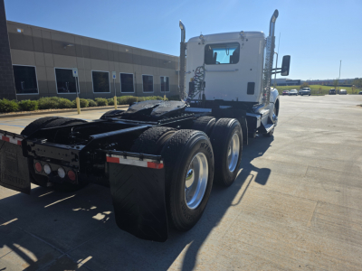 2021 Kenworth T880 tractor back and cab showing rear wheels and fifth wheel area with mud flaps and bumper lights.