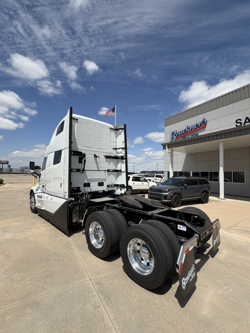 Volvo VNL64T860 semi truck chassis rear view showing sleeper cab and dual rear axles.