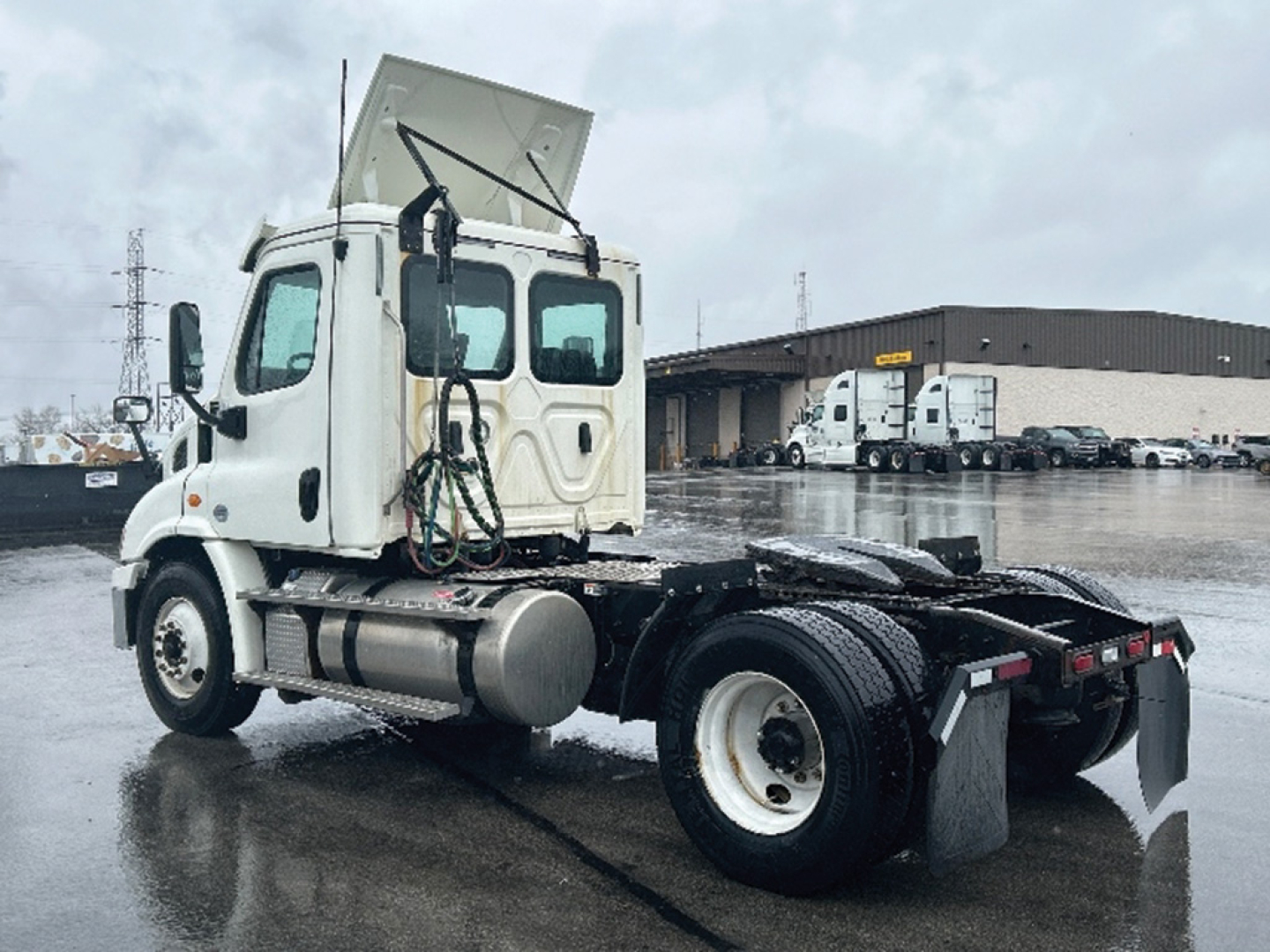 Freightliner Cascadia113 chassis showing rear view with cab and exposed fuel tanks.