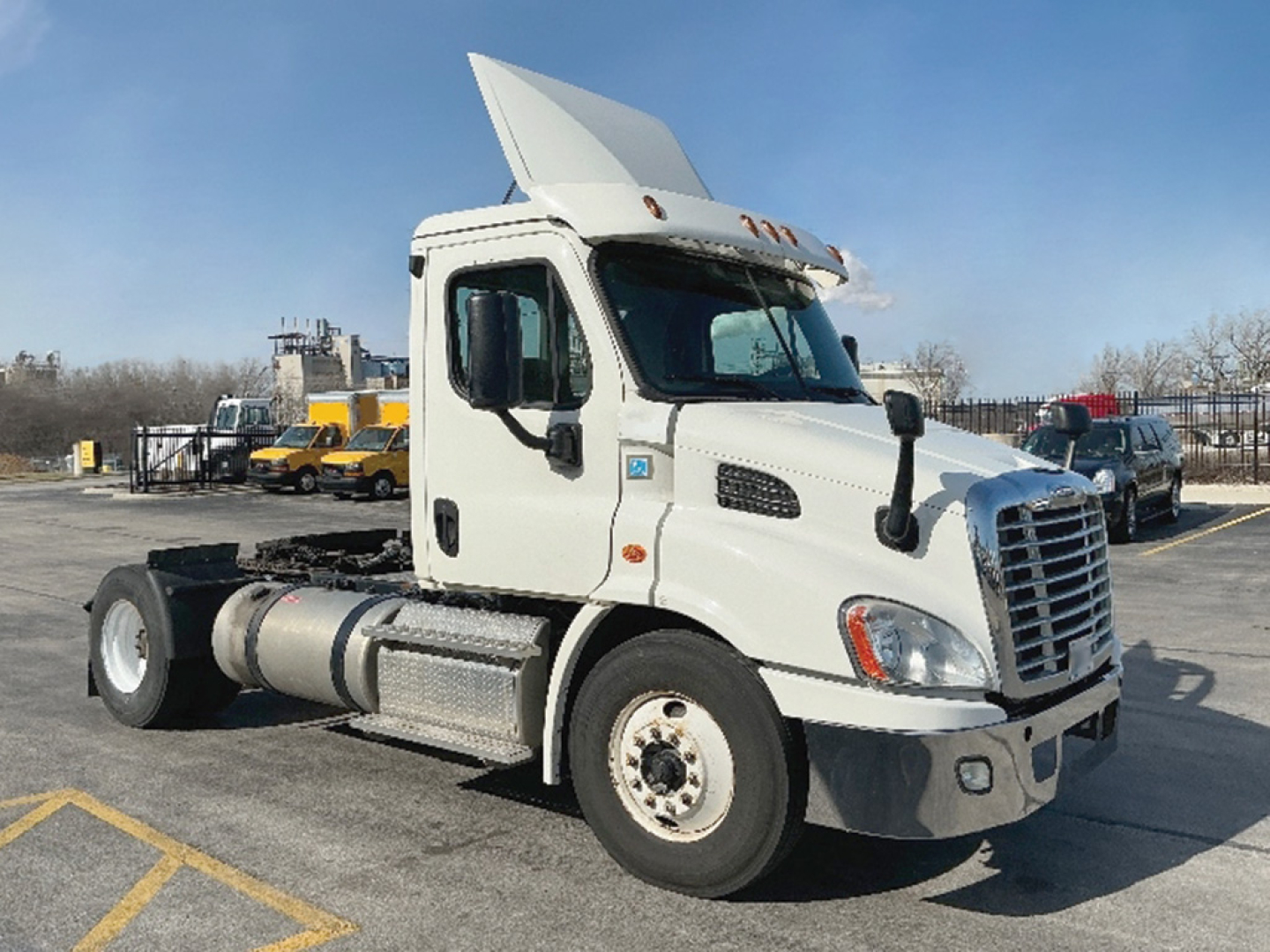 Freightliner Cascadia113 tractor sleeper with raised hood, white cab, front chrome grille, large side mirrors, and dual fuel tanks.