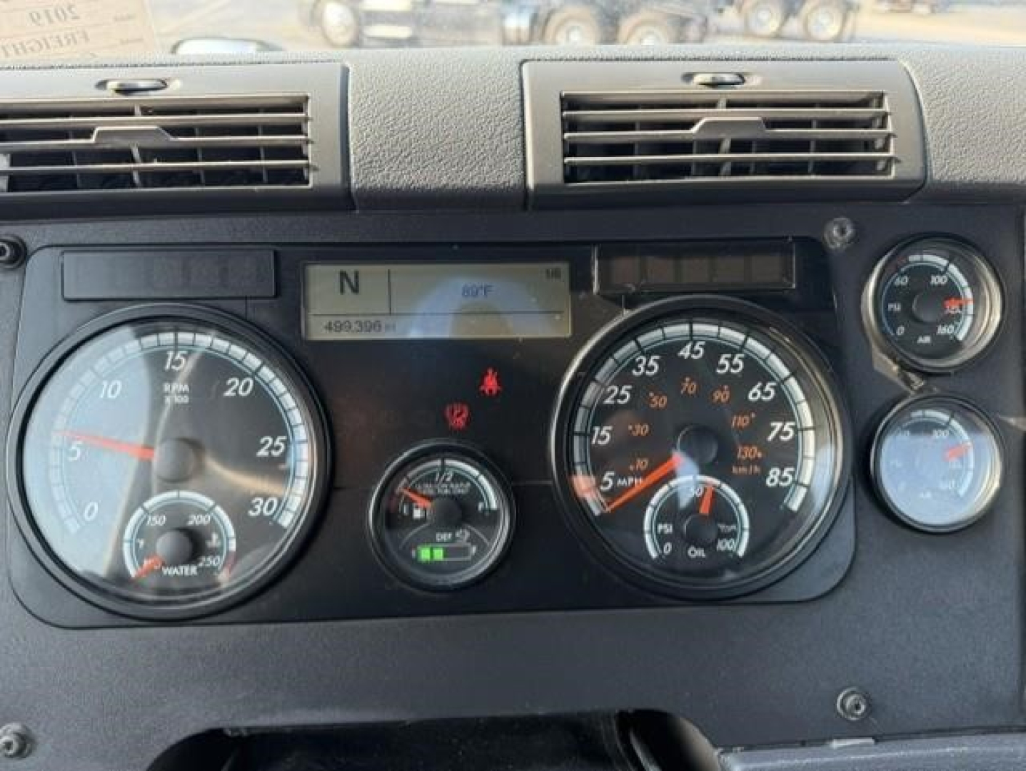 Dashboard of a 2019 Freightliner Cascadia 126 day cab showing gauges and warning lights. Instrument cluster includes speedometer, tachometer, and secondary gauges with digital readout.