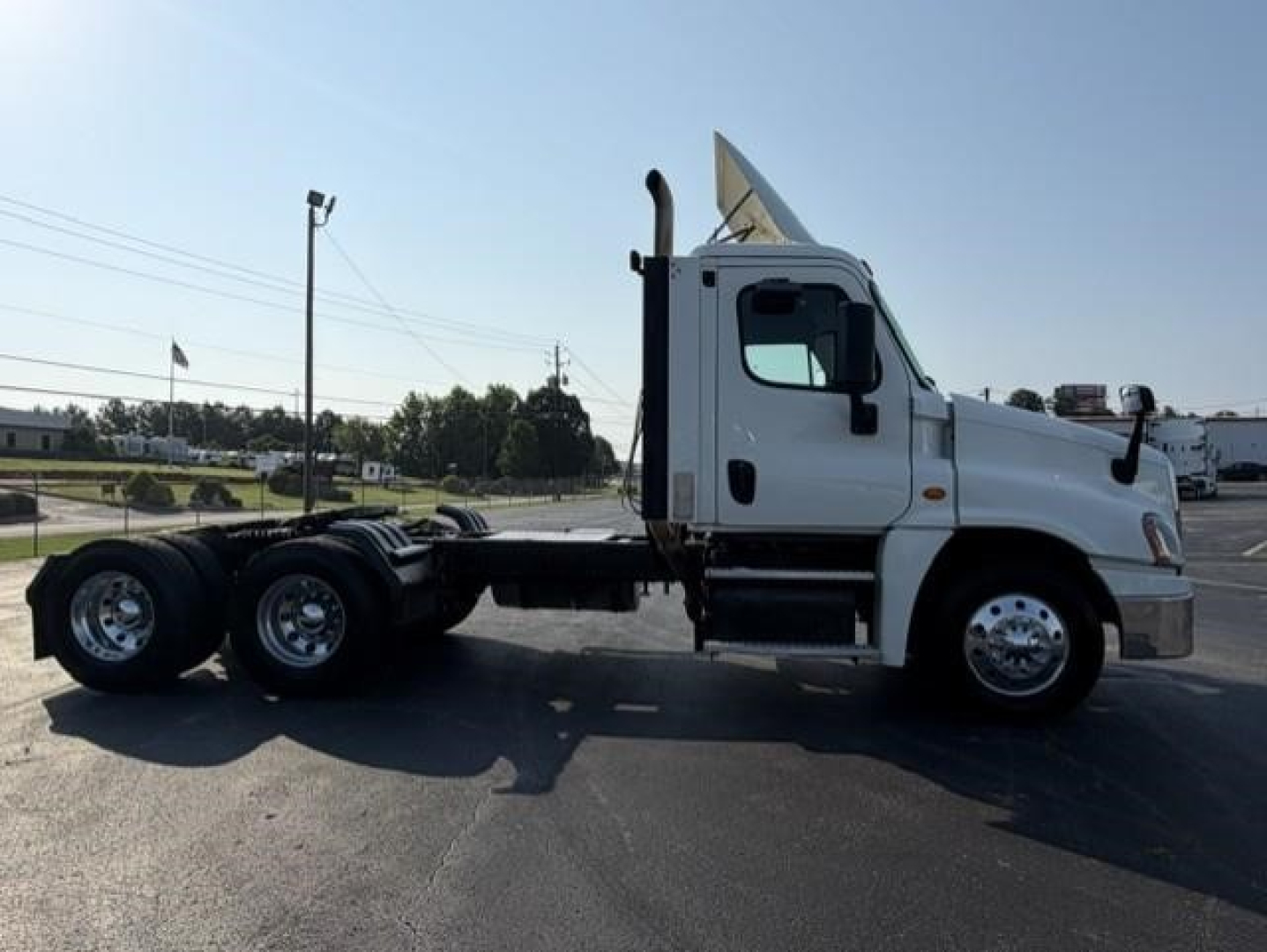 Freightliner Cascadia 126 side view showing truck chassis and cab with white paint.