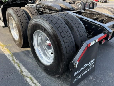 Freightliner Cascadia 126 rear axle and dual tires showing fifth wheel area and mudflap with Select Trucks branding.