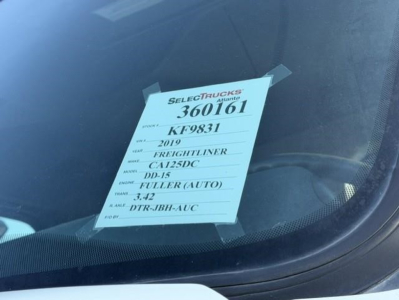 Tag on windshield showing stock 360161, KF9831, 2019 Freightliner Cascadia DD-15 FullER (AUTO)