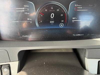Kenworth T880 instrument cluster display showing speedometer at 0 mph, various gauges, and trip data; VIN and stock number not visible on the gauge face.