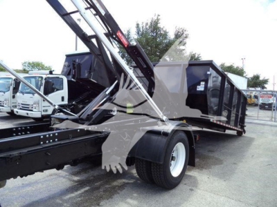 2019 International 4300 roll-off truck showing crane arm and dump body with dual rear wheels. Visible text includes stock and model features on side panels.