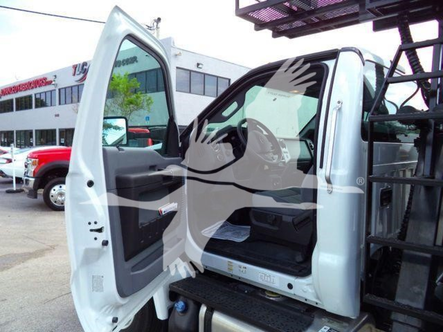 Ford F650 grapple truck cab interior showing open door and step with visible controls