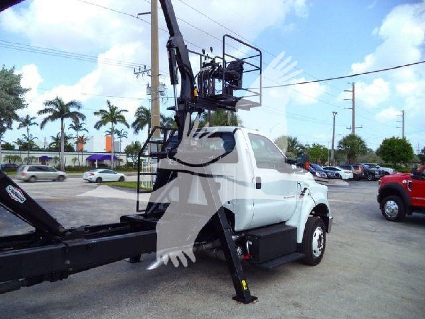 Ford F650 grapple truck with mounted hydraulic crane and basket showing side view.