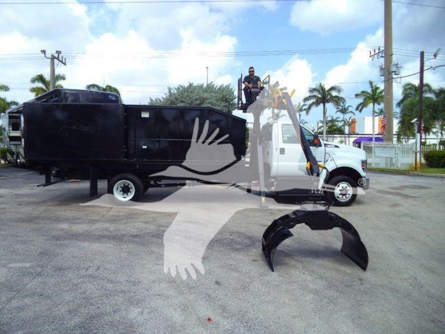 Truck cab and grapple loader with a black attached container and a detached grapple bucket in front; watermark overlay from listing.