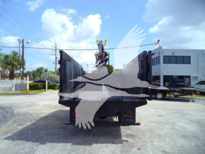 Rear view of a new Ford F650 grapple truck with hydraulic grapple in bed, stock number 21YARDGRAPPLE visible, in a dealership lot.