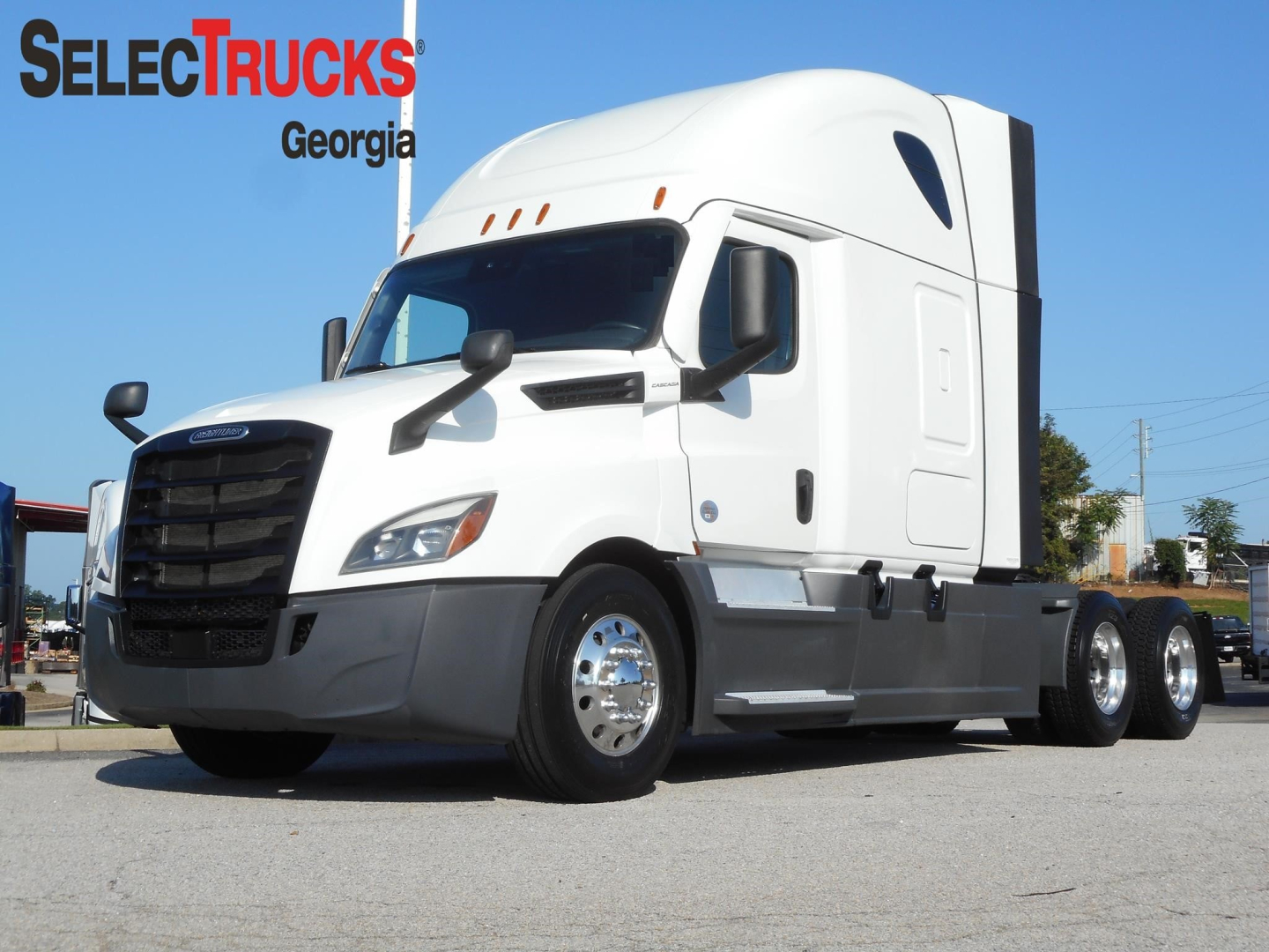 Freightliner Cascadia 126 tractor in showroom pose with SelectTrucks Georgia watermark; white cab, black grille, sleeper bunk, dual rear axles.