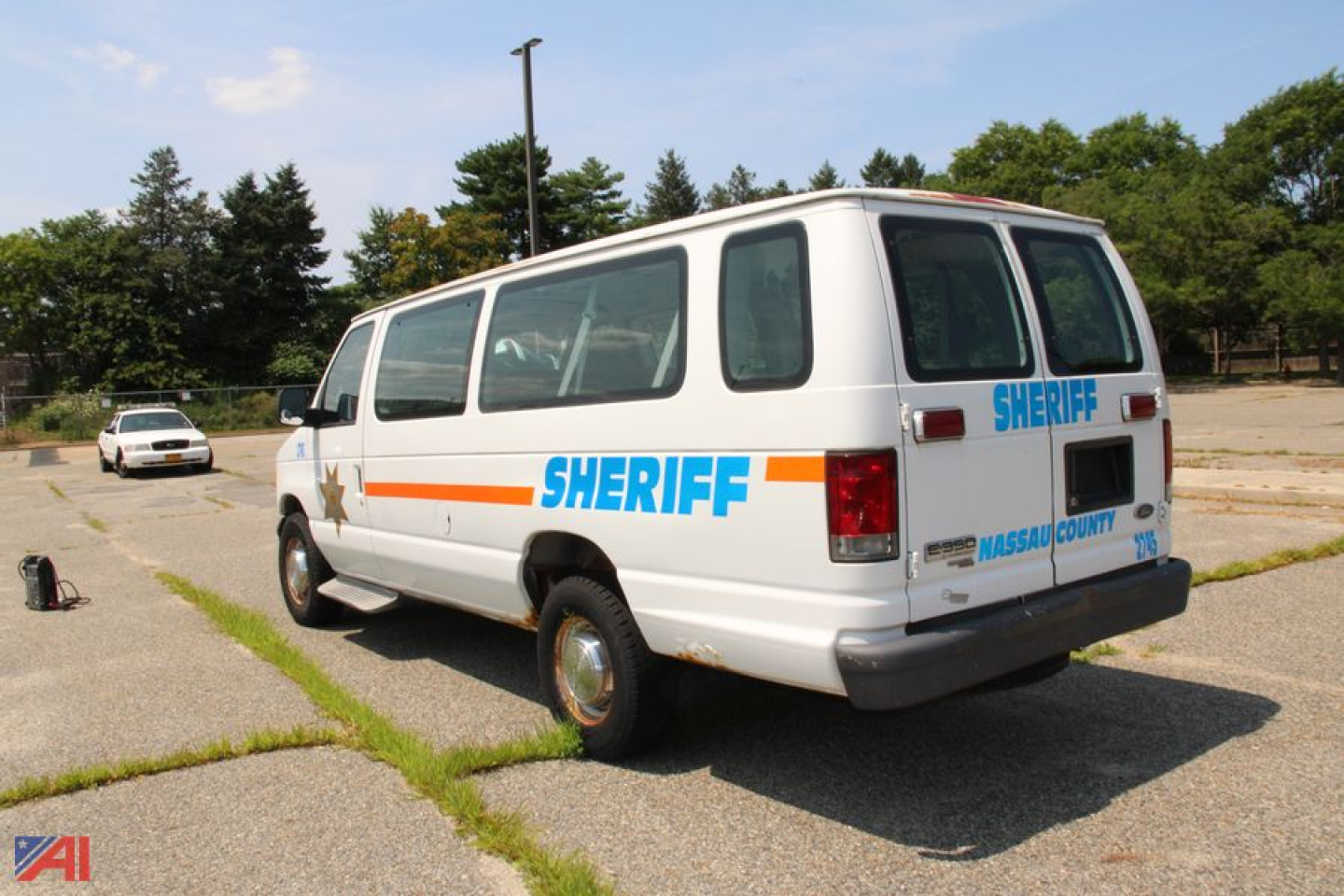 Ford E350 van with Nassau County Sheriff markings in a parking lot, rear three-quarter view.