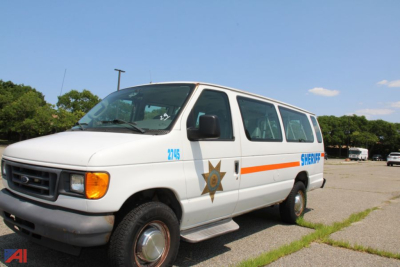 2006 Ford E350 van with Sheriff emblem and orange stripe, side view showing front and passenger windows, wheel wells, and step rail.