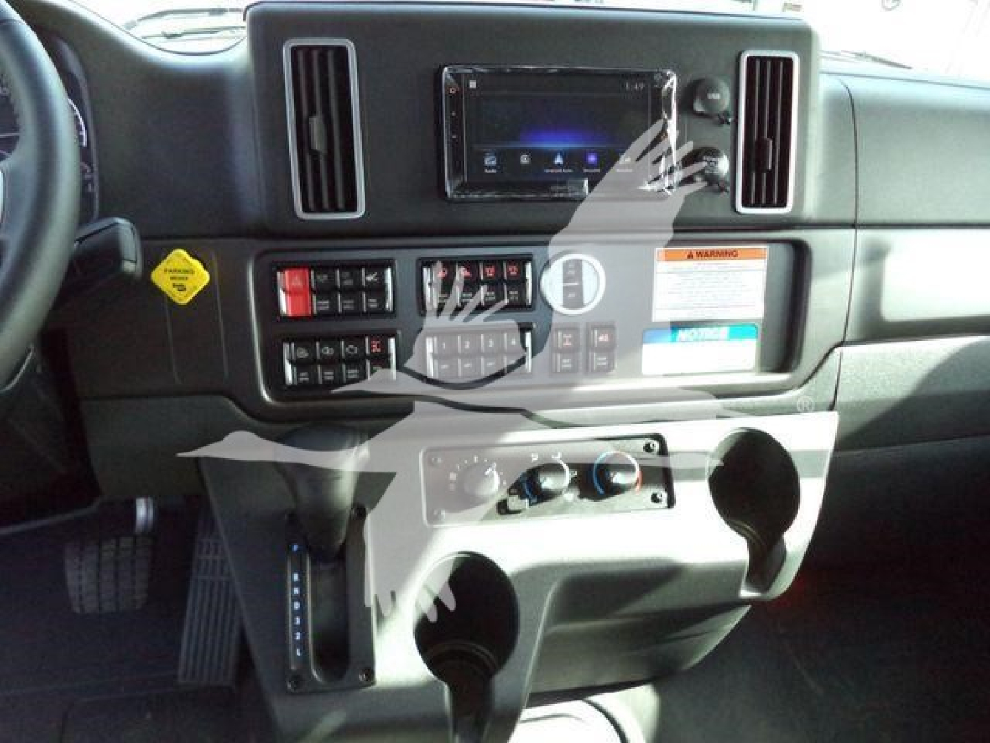 Cab interior of a 2027 Freightliner Business Class M2 106 dashboard with steering column, center console, and control panel visible.