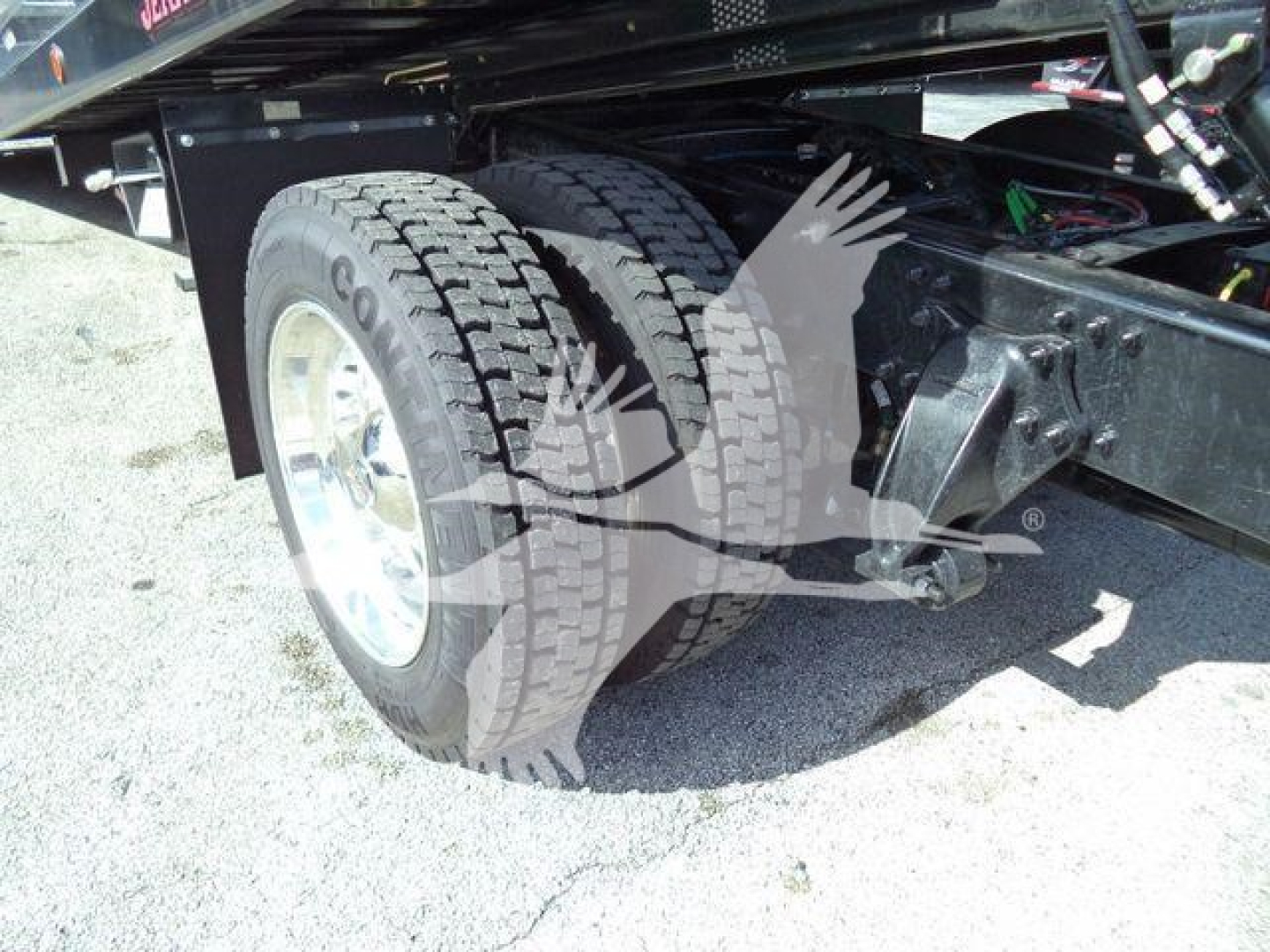 Freightliner Business Class M2 106 rear dual rear tires and suspension showing wheel and axle components.
