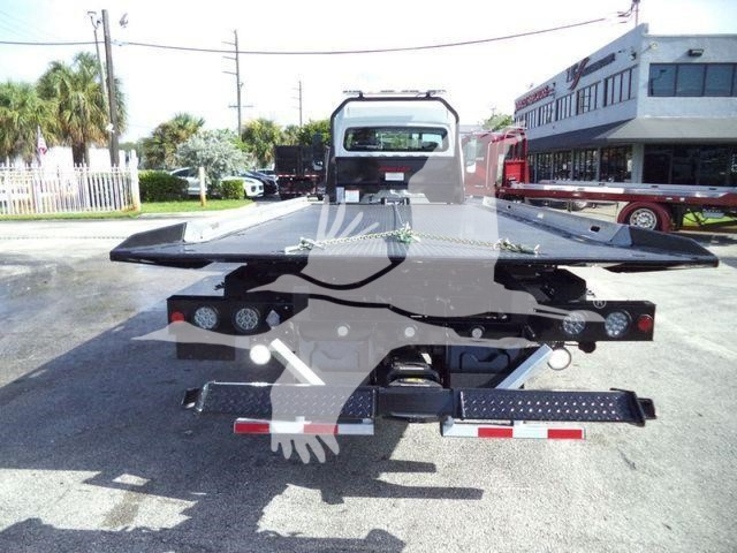 Freightliner Business Class M2 106 rollback truck bed with rear view showing platform and lighting, license plate not visible, no legible text identified.