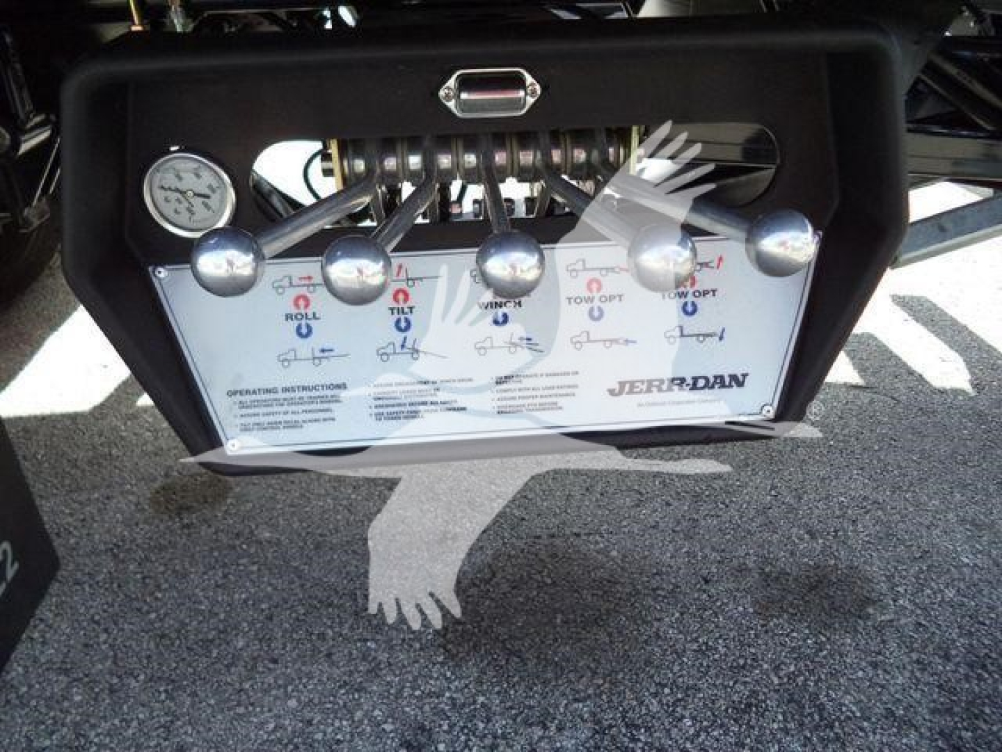 Panel with multiple levers and labels for a tow truck control system. Visible text includes 'JERRDAN' branding, various color-coded lever labels, and operating instructions.