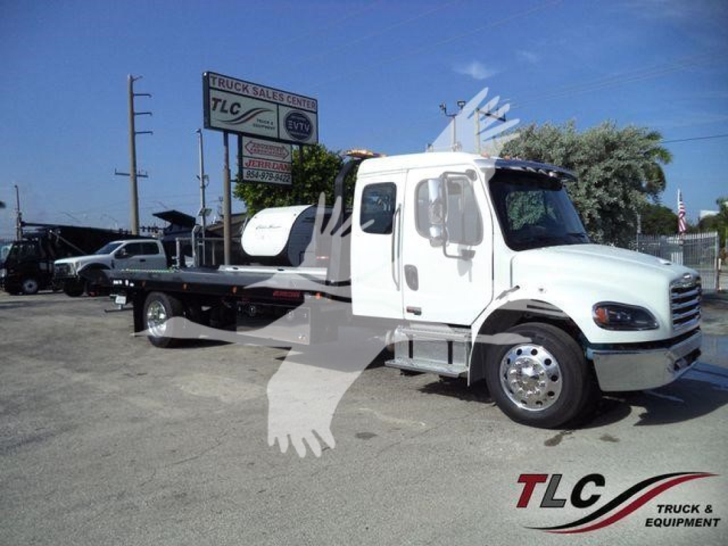 Truck: 2027 Freightliner Business Class M2 106 rollback body with tow bed, white cab, side mirrors, dual mirrors, large front grille, logo on door.