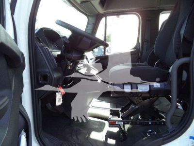 Freightliner Business Class M2 106 truck cab interior showing cabin and driver's seat with steering wheel and controls.