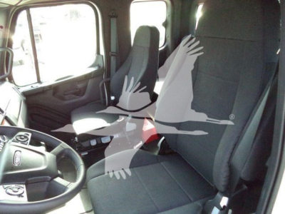 Freightliner Business Class M2 106 interior view showing driver seat and front passenger seat.