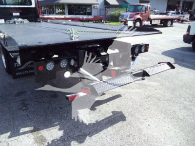 Freightliner Business Class M2 106 rollback truck rear showing dual flatbed ramps and LED lights.